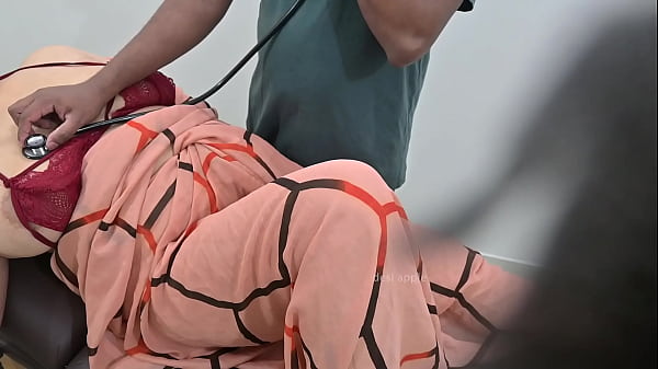 Indian doctor checking lady patient in clinic